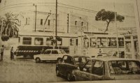 Microbus del servicio urbano junto a un paso a nivel, años 80